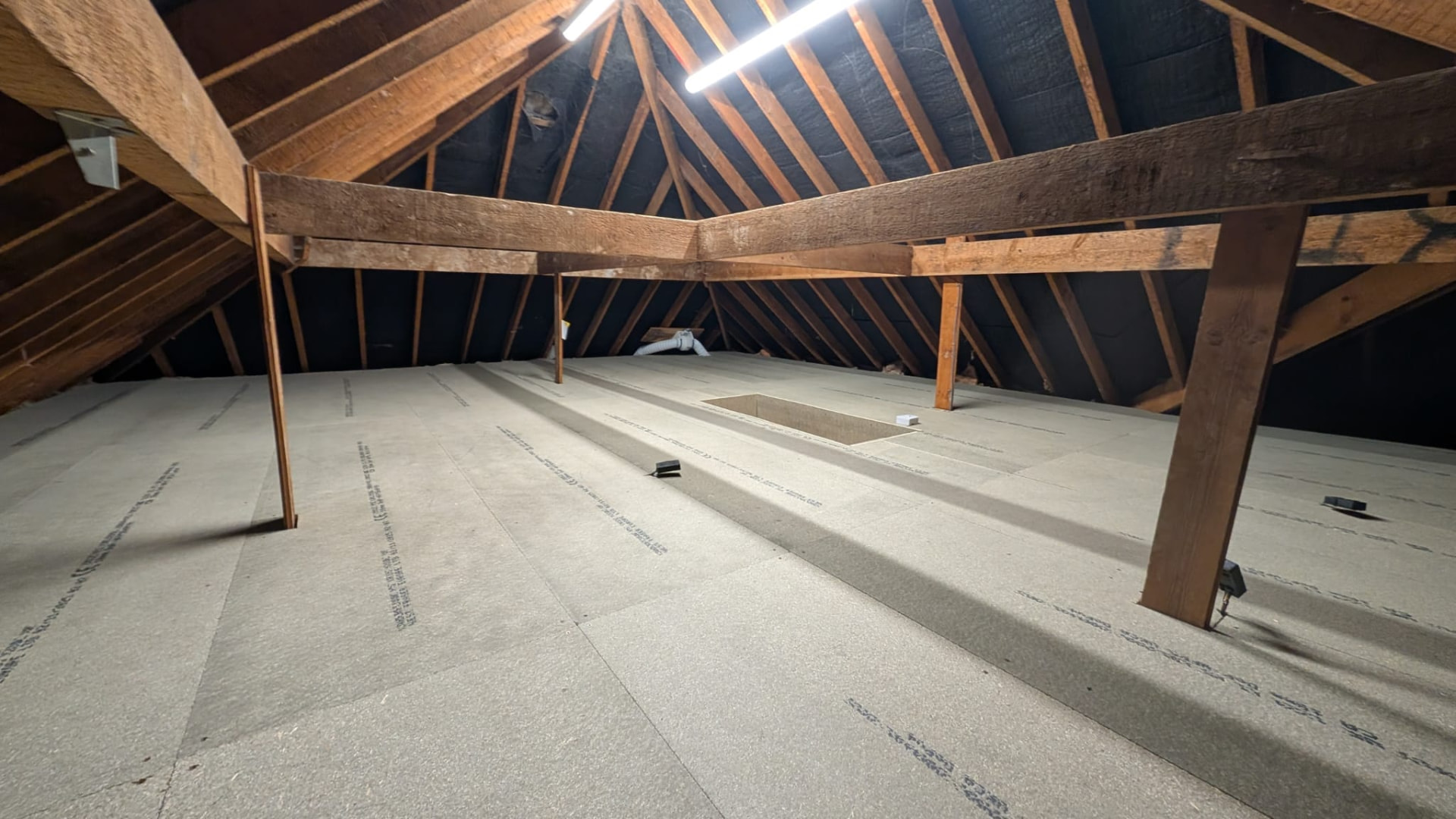 Loft after install, full-width structural chipboard floor with insulated hatch surround