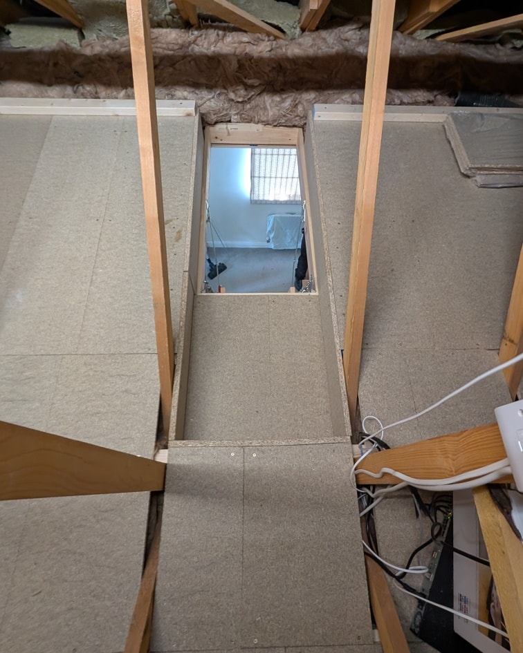 P5 chipboard loft boards laid through new-build roof trusses