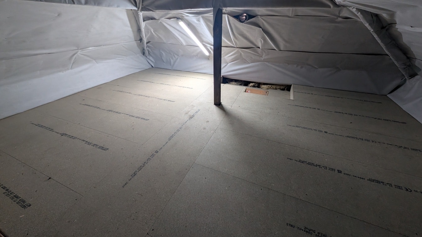 Loft boarding finished beneath foil-membrane lined roof slope