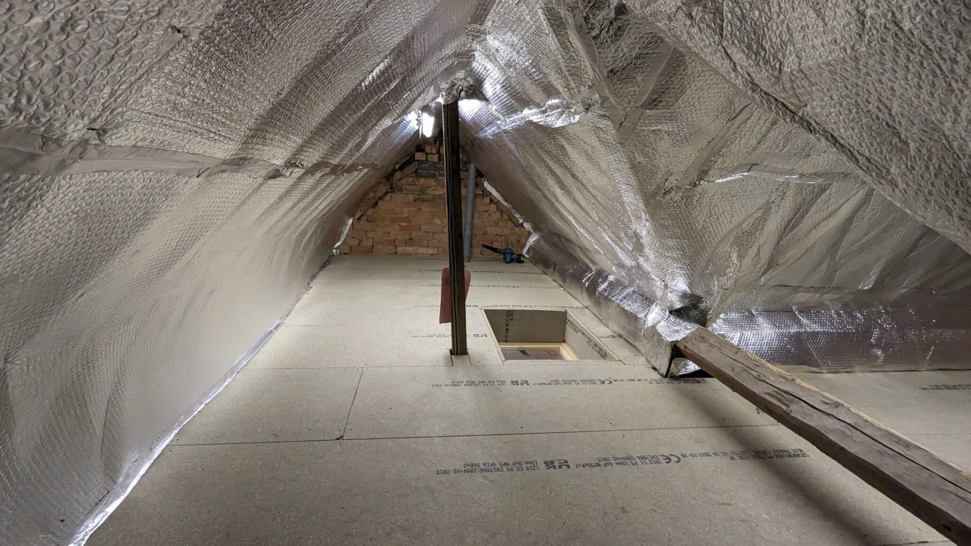 Foil bubble insulation lining over rafters with boarded floor