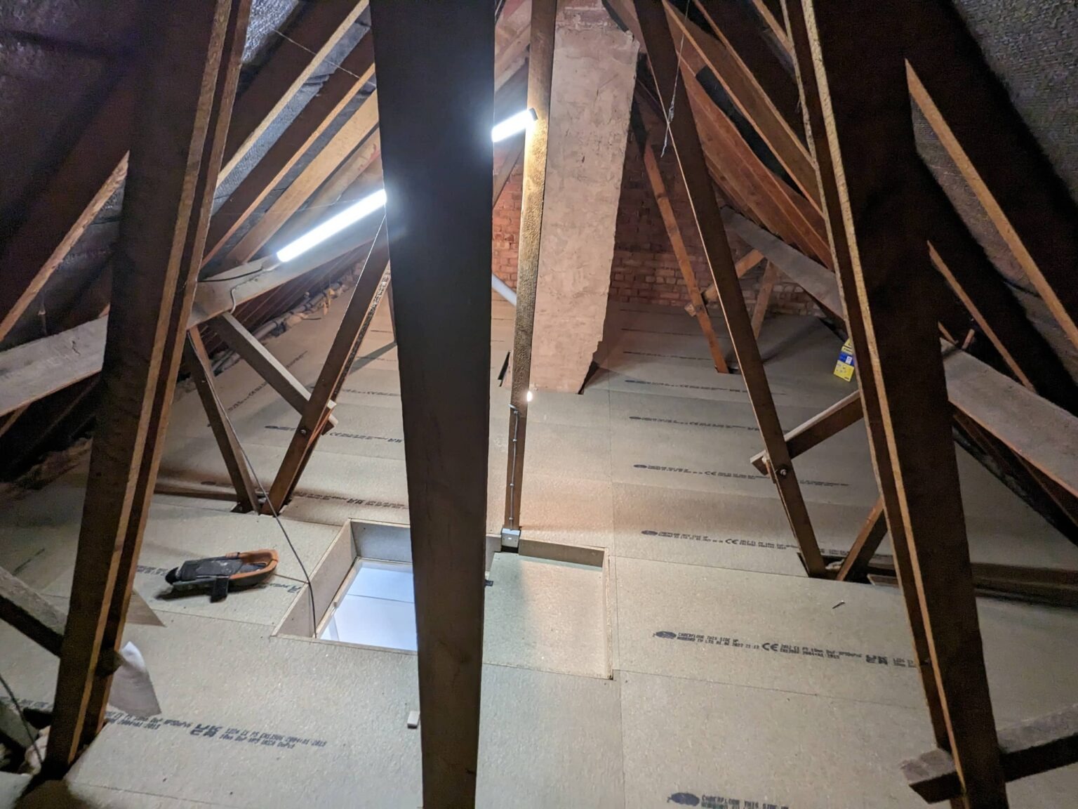 Loft boarding completed with clean cuts around bracing