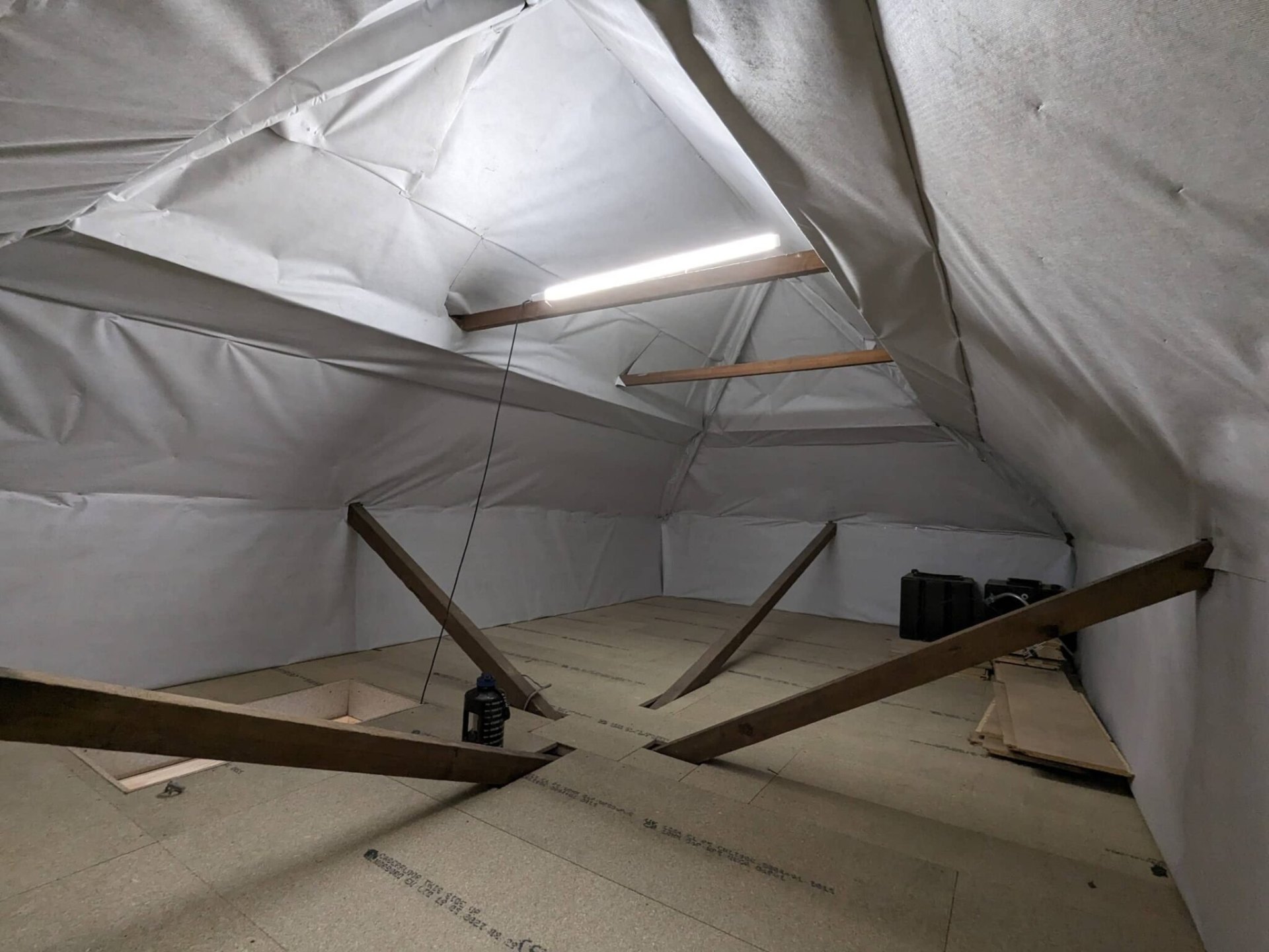 Foil membrane loft lining with strip light over boarded floor