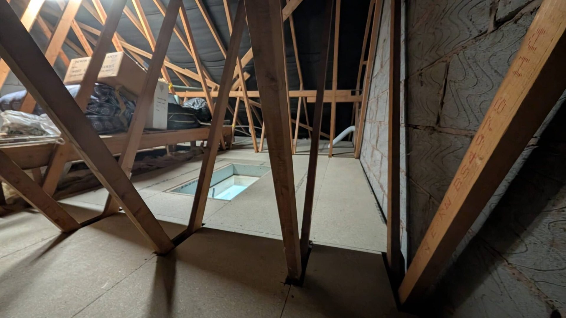 Boarded loft floor with chipboard panels fitted between trusses, Solihull