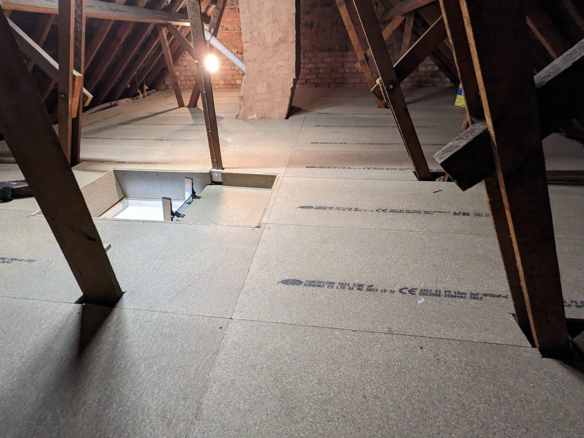 Fully boarded loft floor with hatch and chimney breast, professional install