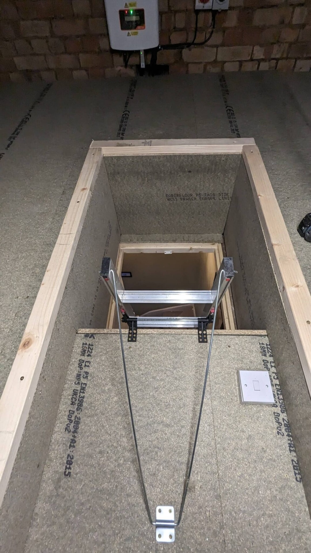 Timber-framed loft hatch surround with concertina ladder fitted