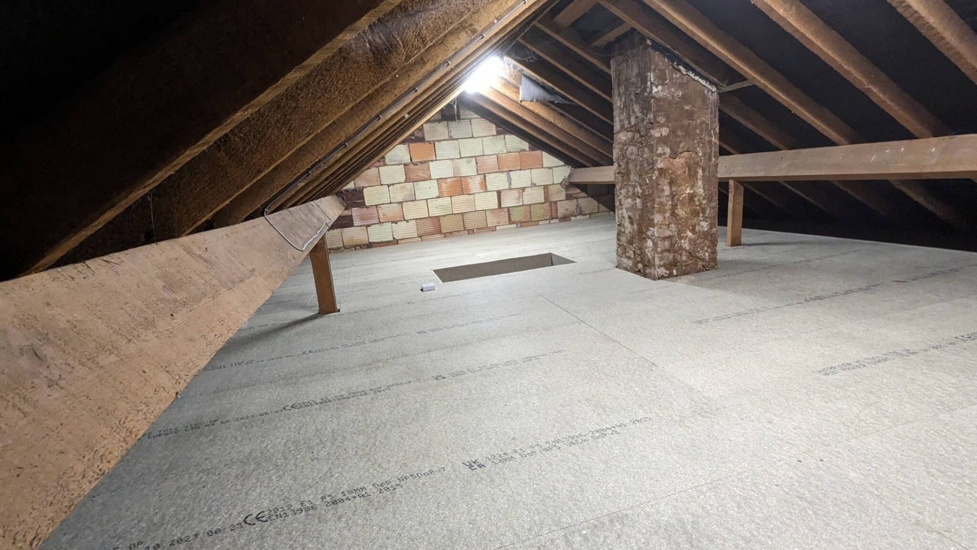 Loft boarding around chimney breast with clean cuts, Solihull project