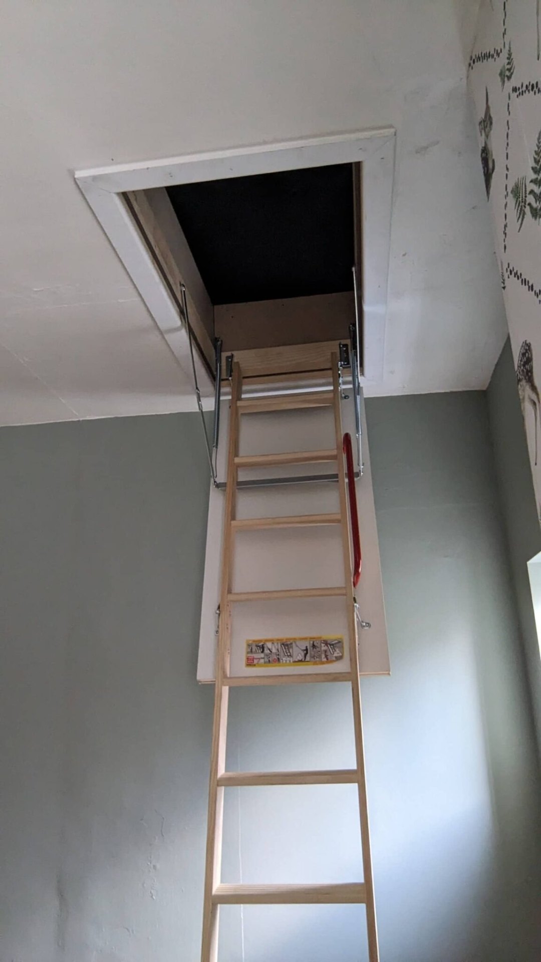 Three-section wooden loft ladder fully extended, safe install
