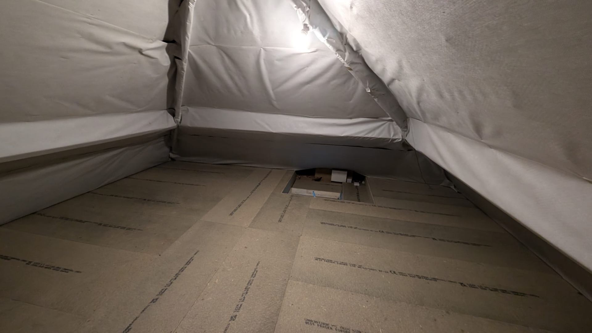 Loft boards laid over original mineral wool insulation