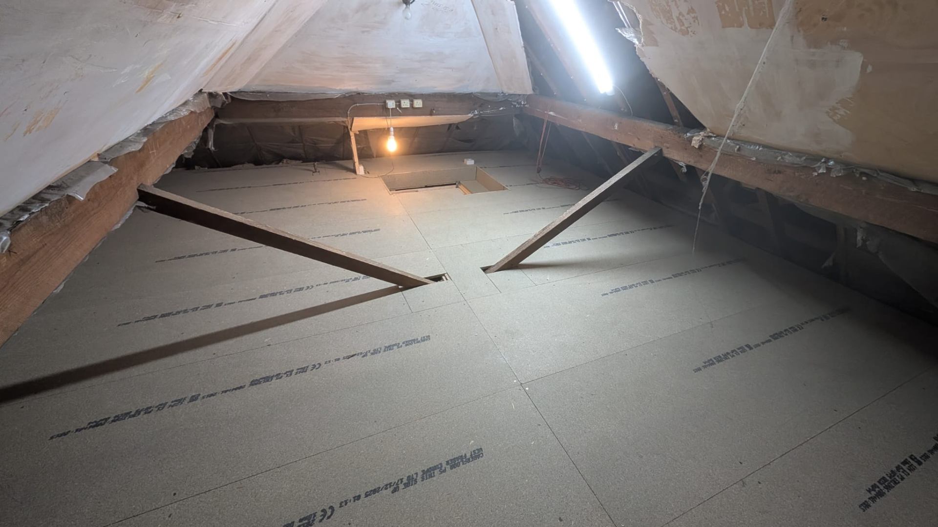 Loft boarding completed with clean cut around chimney pipe