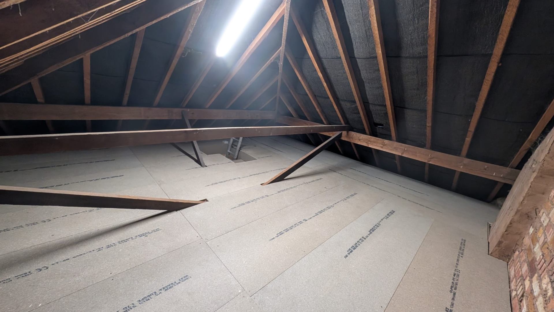 Tongue-and-groove loft boards installed across main attic span