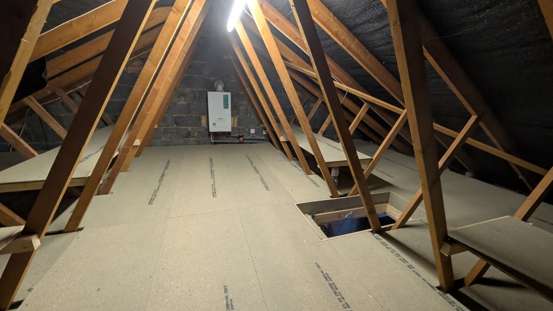 Finished loft boarding with neat perimeter cuts to eaves