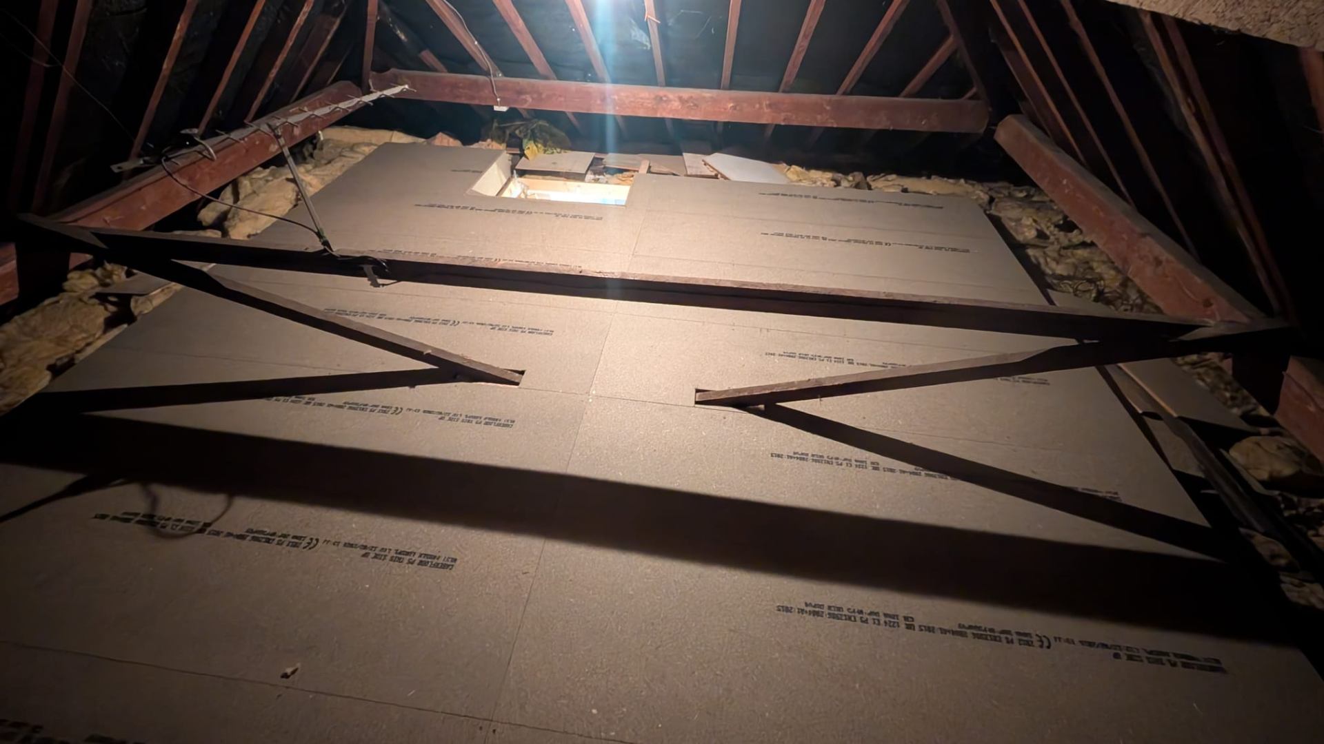 Long boarded walkway through trussed roof loft