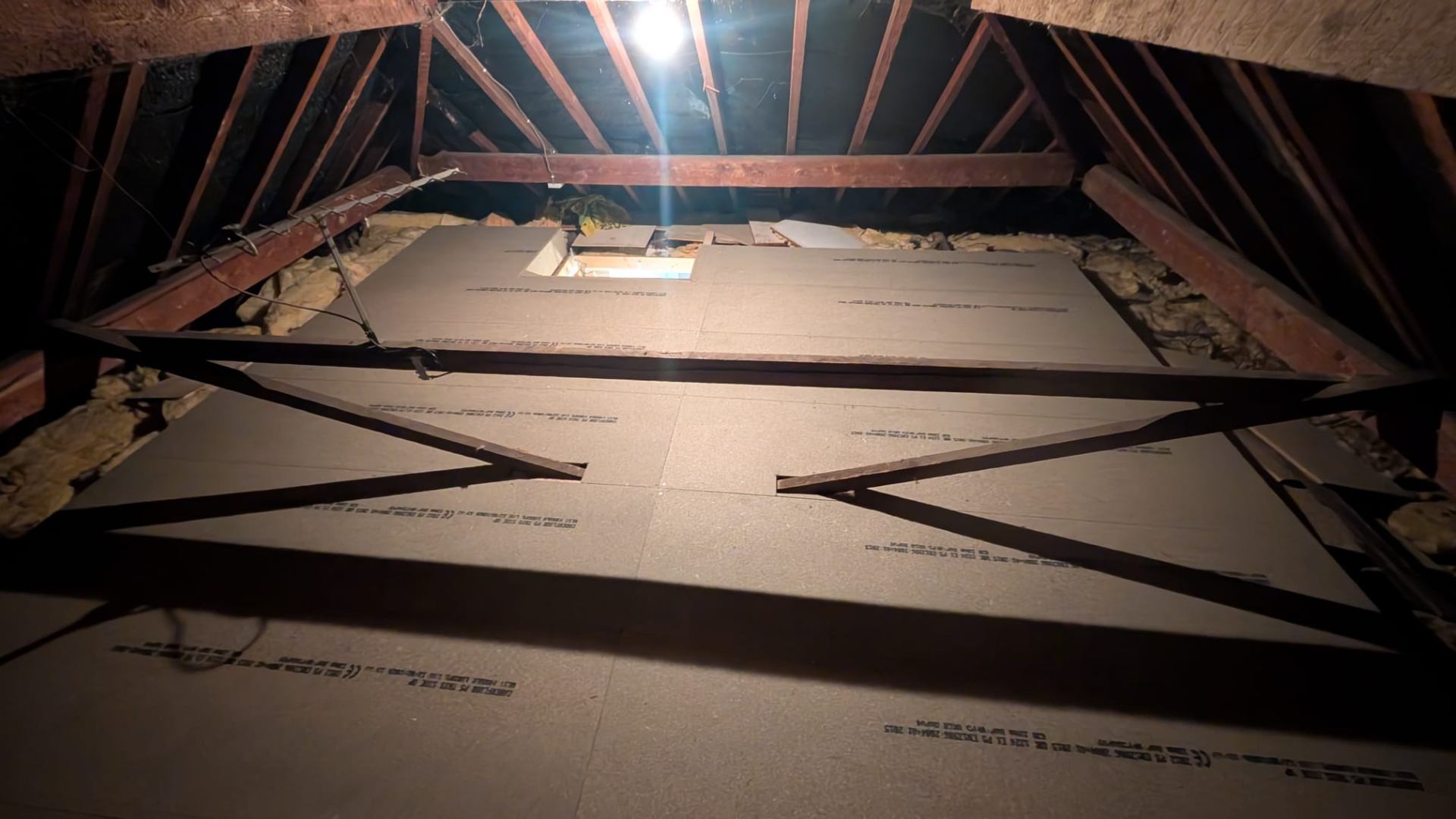 Loft boards installed neatly around vertical bracing