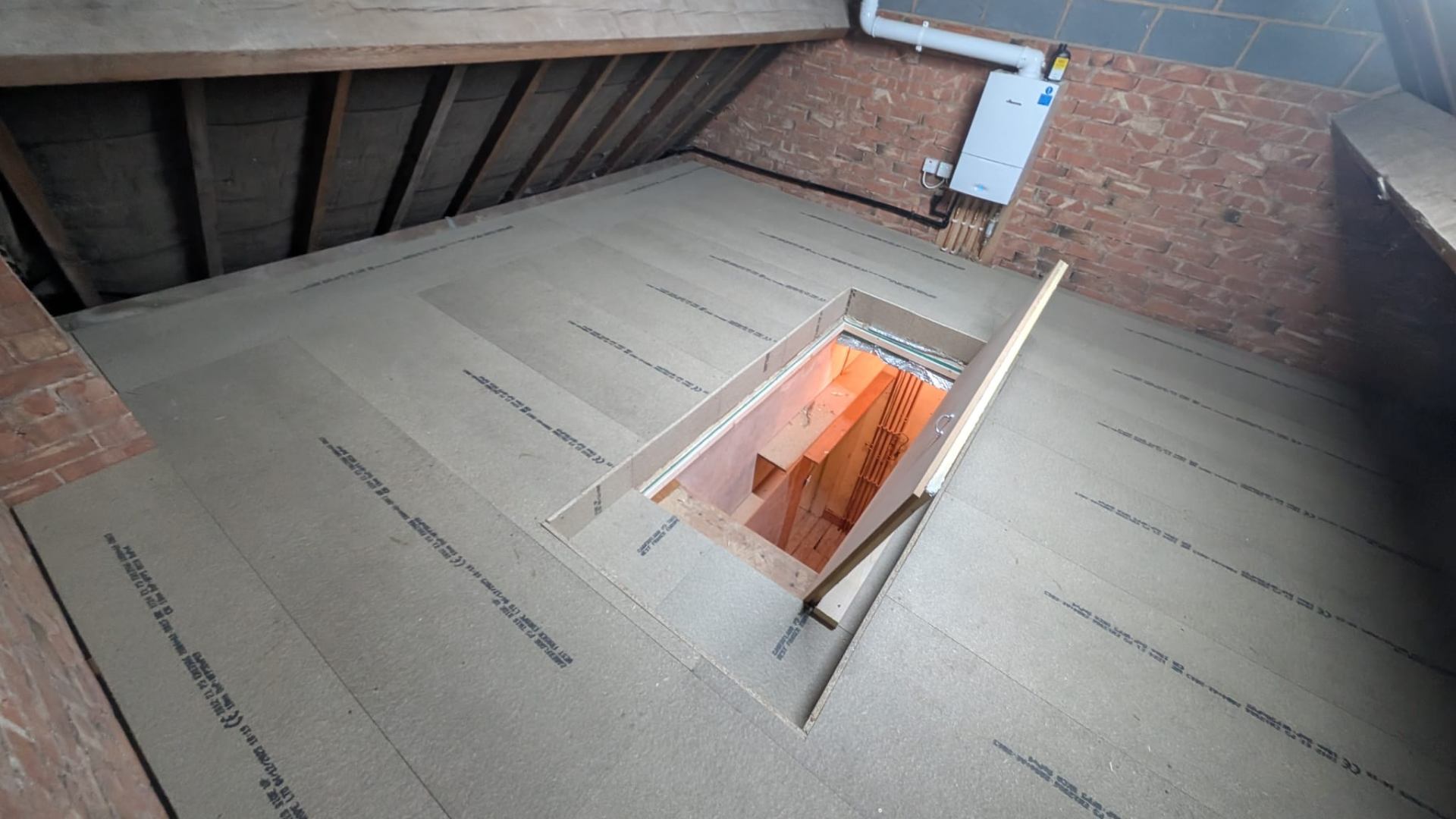 Loft boarding fitted around joists and bracing