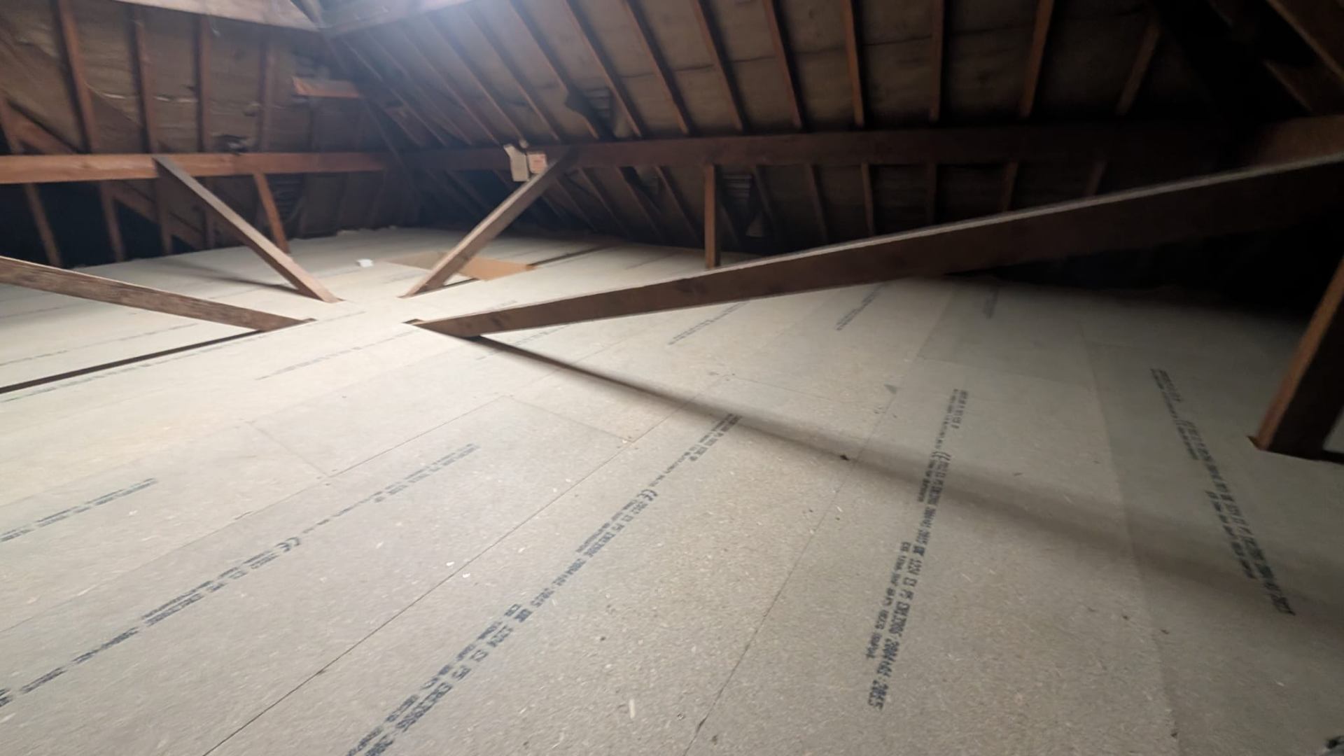 Boarded loft floor across original timber joists